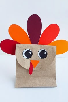 a paper bag with a turkey on it's side and eyes painted on the inside