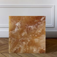 an image of a marble tile on the floor in front of a white paneled wall