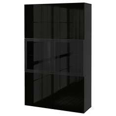 a black bookcase with glass doors on the front and bottom shelves, all facing different directions