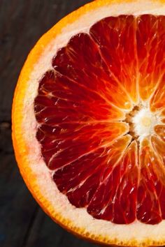 an orange cut in half sitting on top of a table