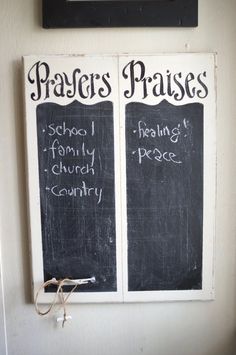 two blackboards with writing on them hanging from the wall