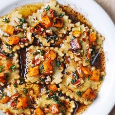 a white plate topped with pasta and vegetables