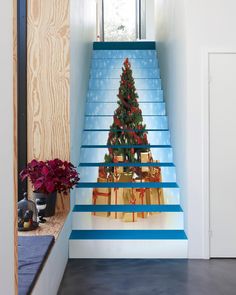 a christmas tree painted on the side of a stair case