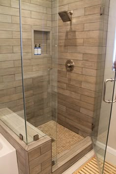 a walk in shower sitting next to a bath tub