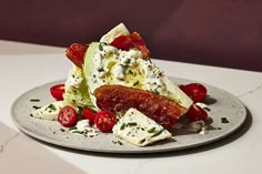 a white plate topped with salad and meat