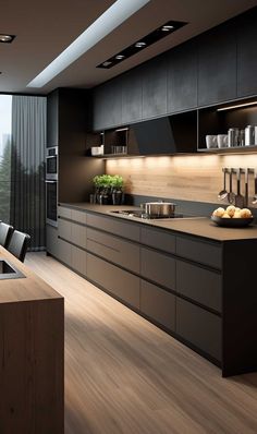 a modern kitchen with black cabinets and wood flooring is seen in this image from the side