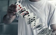 a man holding playing cards in his hands