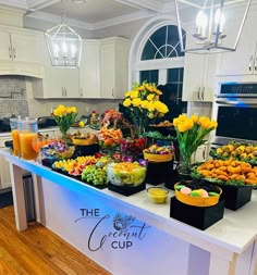 a kitchen filled with lots of food on top of a white counter next to a refrigerator