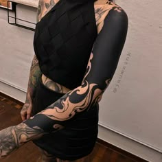 a woman with tattoos on her arm and arms