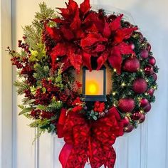 a christmas wreath with a lit candle on it