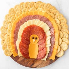 a turkey and cheese platter with crackers on the side