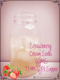 strawberry cream soda in a glass jar with strawberries