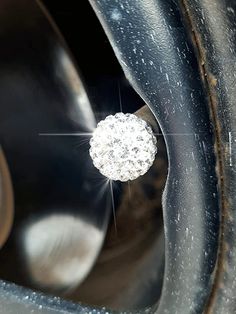 a close up of a metal object with water droplets on the top and bottom part