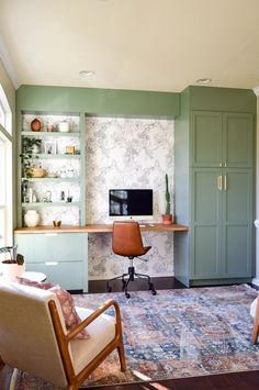 a living room filled with furniture and green walls