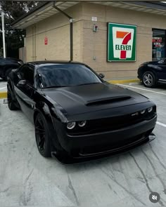 a black car parked in front of a 7 eleven gas station