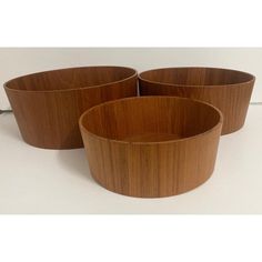 three wooden bowls sitting next to each other