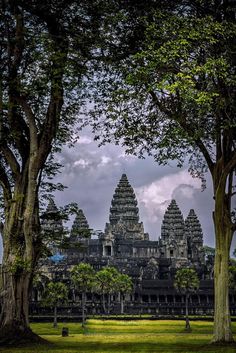 an ancient building with trees in the foreground