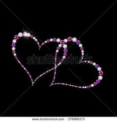 two hearts made out of pearls and pink crystals on black background with space for text