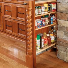 a kitchen island with spice rack in the middle and drawers on both sides next to an oven