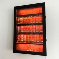 a display case with many glasses in it