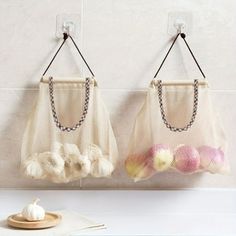 two bags hanging from hooks on the wall