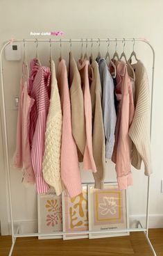 there are many sweaters hanging on the rack