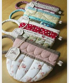 several small purses sitting on top of a wooden table