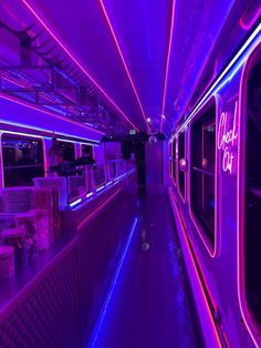 the inside of a subway car with neon lights on it's walls and windows