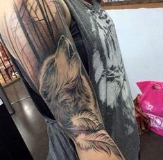 a man with a wolf tattoo on his arm