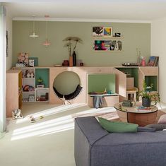 a living room filled with furniture and lots of shelves