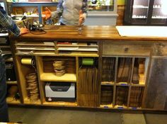 a man standing in front of a wooden counter