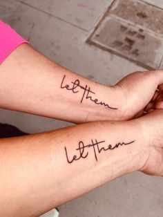 two people with matching tattoos on their arms that say, let them be together and the words are written in cursive font