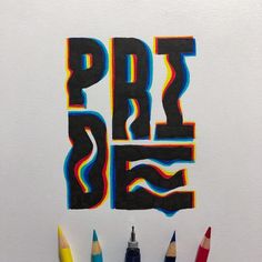 some colored pencils are in front of a piece of paper with the word art on it