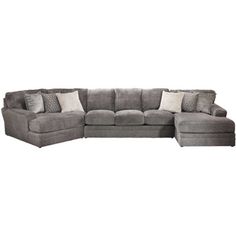 a large gray sectional couch with pillows on the top and bottom corner, in front of a white background