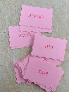 four pink placemats with names on them