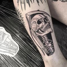 a man's leg with a skeleton tattoo on it