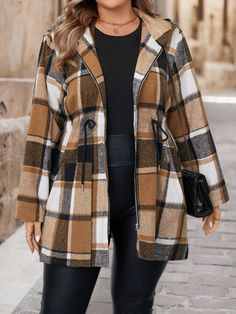 a woman in black leggings and a plaid coat