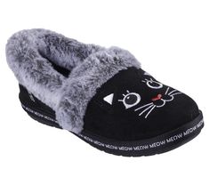 Cuddle up with your four-legged bestie in purrfect comfort with Skechers Hands Free Slip-ins BOBS from Skechers Too Cozy - Meow PJ's. This casual slipper features a vegan suede upper with an embroidered 3-D Black Cat face design, faux-fur trim, and a cushioned Skechers Memory Foam footbed. For every BOBS purchase, a donation is made to animals in need. | Skechers Women's Slip-ins: BOBS Too Cozy - Meow PJ's Shoes | Medium Width | Skechers Hands Free Slip-ins for an easy fit | Skechers Memory Foam cushioned comfort footbed | Crafted with 100% vegan materials | Vegan suede upper | Embroidered 3-D Black Cat face design with a faux-fur trim | Midsole with 'Meow Meow Meow' print all the way around | Slip-on casual comfort slipper design | Indoor/outdoor flexible traction outsole | BOBS from Skec Black Cat Face, Faux Fur Top, Skechers Bobs, Black Slippers, Designer Slippers, Casual Slippers, Skechers Women, Clean Shoes, Face Design