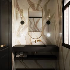 an elegant bathroom with marble walls and black counter tops, gold accents on the mirror