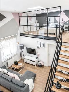 a living room filled with furniture and stairs