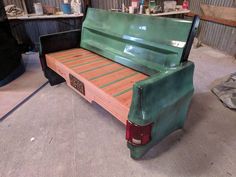 a green truck bed sitting inside of a garage