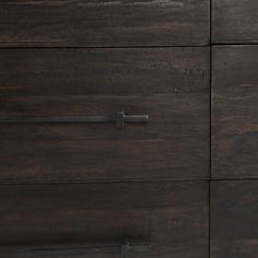 a wooden dresser with metal handles on it's doors and drawer pulls in dark wood