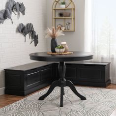 a black table sitting on top of a white rug