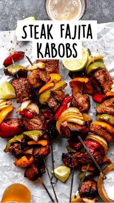 several skewers of meat and veggies on a sheet of paper