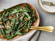 cooked green beans with bacon and parmesan cheese in a bowl on a table