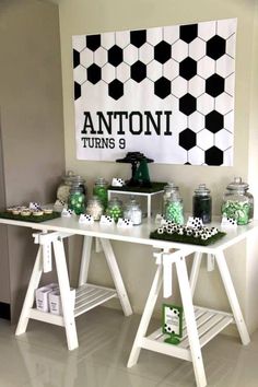 a white table topped with lots of green candies