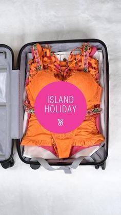 an open suitcase with clothes in it and the words island holiday written across the top