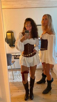 two women dressed in costumes taking a selfie