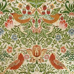 an intricately decorated wall hanging with birds and flowers on it's sides, surrounded by leaves and berries