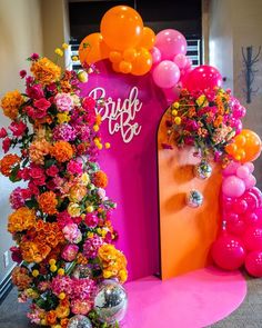 an entrance decorated with flowers and balloons